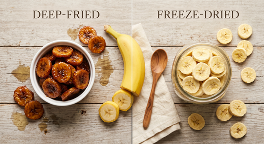 Side-by-side comparison of processed banana chips versus freeze-dried banana slices on a wooden farmhouse table with a fresh banana for reference
