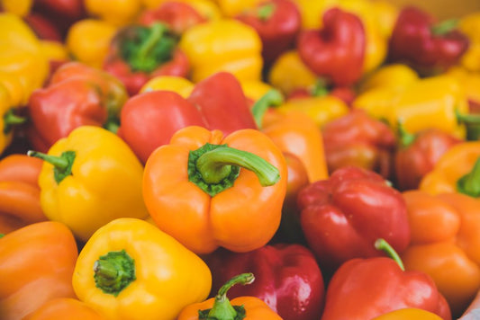 Colorful mix of red, yellow, and green bell peppers ready for cooking