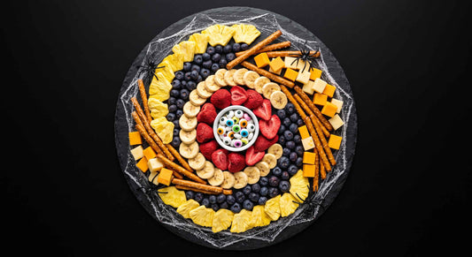 Halloween snack board with freeze-dried fruit, cheese, and spooky treats