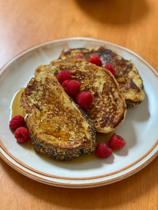 Stack of golden French toast slices topped with syrup, one of six French toast recipes from Mother Earth Products